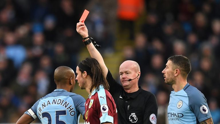 Referee Lee Mason shows the red card to Fernandinho for his challenge on Johann Gudmundsson