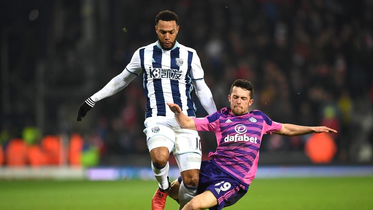 Matt Phillips of West Bromwich Albion (L) is tackled by George Honeyman of Sunderland (R)