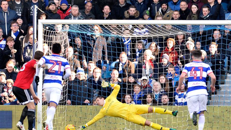 Alex Smithies of Queens Park Rangers (C) saves Chris Martin of Fulham FC (L) penalty during the Sky Bet Championship match 