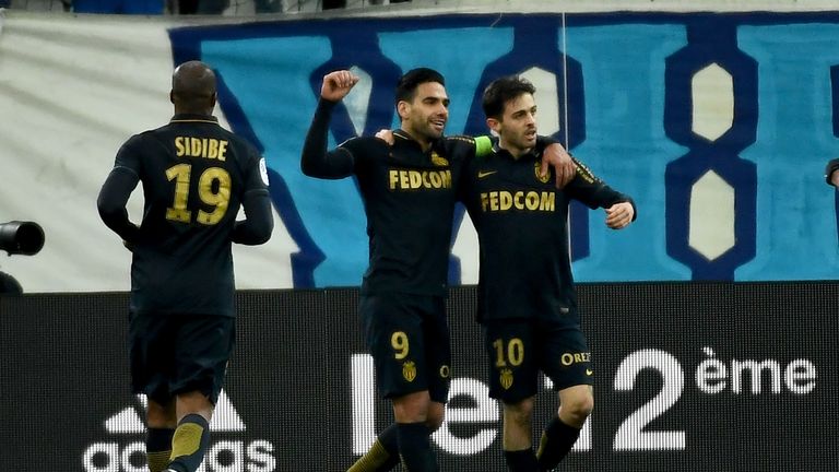 Monaco's midfielder Be Mota Veiga de Carvalho E Silva (R) is congratulated by teammates after scoring a goal during the French L1 football match Marseille 
