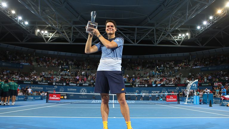 BRISBANE, AUSTRALIA - JANUARY 10:  Milos Raonic of Canada holds the winners trophy after winning the Mens Final against Roger Federer of Switzerland during