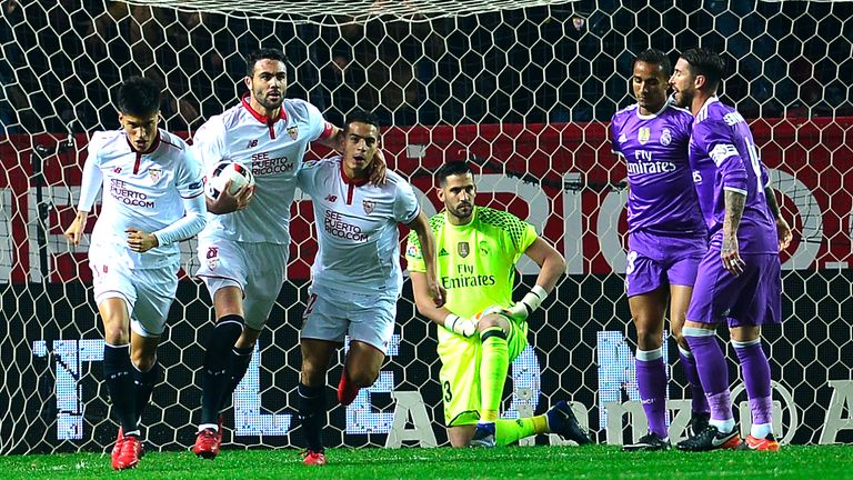 Sevilla's players (L) celebrate after Real Madrid's Brazilian defender Danilo (2ndR) scored an own goal during the Spanish Copa del Rey (King's Cup) round 