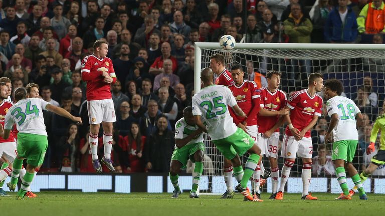 MANCHESTER, ENGLAND - SEPTEMBER 30:  Wayne Rooney of Manchester United in action with Andre Schurrle of VfL Wolfsburg during the UEFA Cham