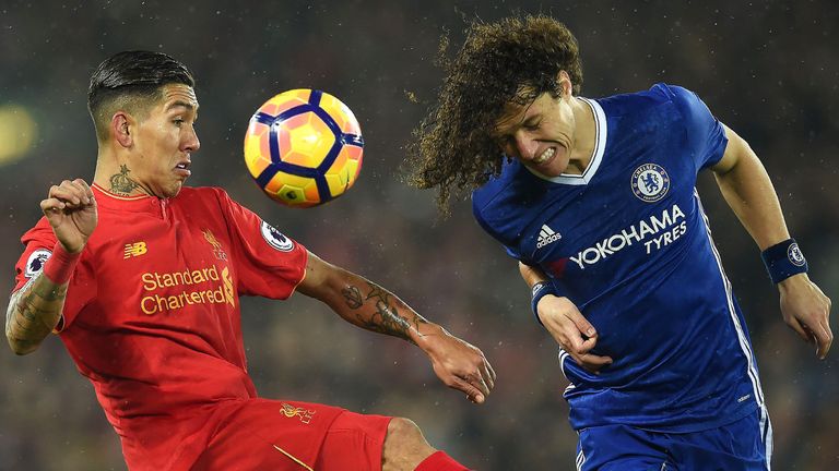 Roberto Firmino (L) vies for possession with David Luiz at Anfield