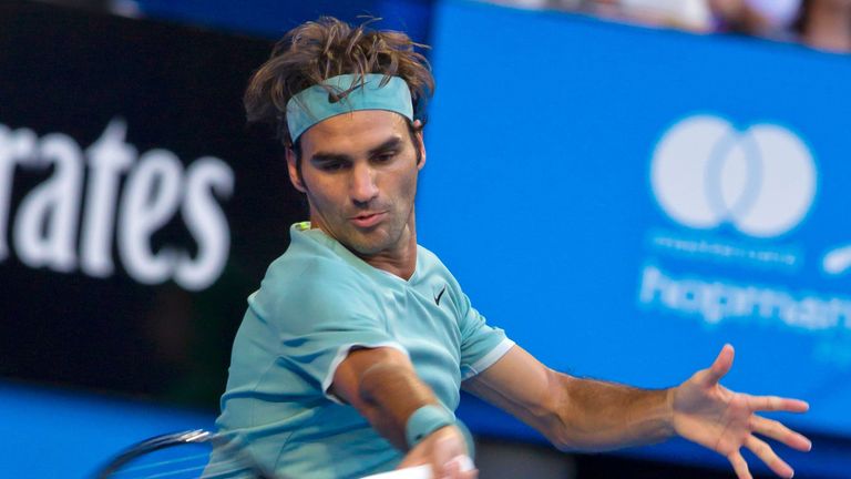 Roger Federer of Switzerland hits a return against Dan Evans of Britain during their fourth session men's singles match on day two of the Hopman Cup tennis