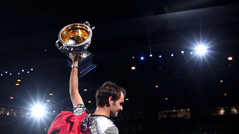 Federer walks off court with the Australian Open trophy