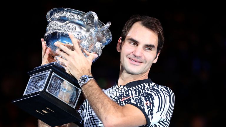 Roger Federer holds the Australian Open trophy aloft for fifth time after seeing off old rival Rafael Nadal in five sets