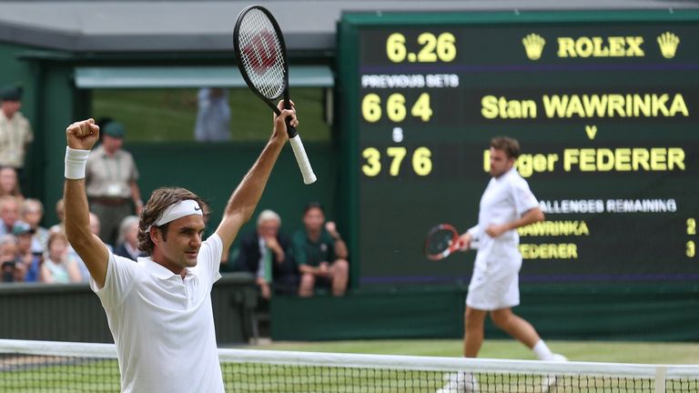 Roger Federer celebrates beating Stan Wawrinka during their men's singles quarter-final of 2014 Wimbledon