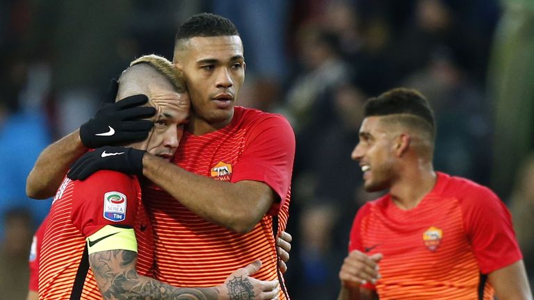 AS Roma's Belgian midfielder Radja Nainggolan (L) celebrates with teammate's Brazilian defender Juan Jesus (C) at the end of the Italian Serie A football m