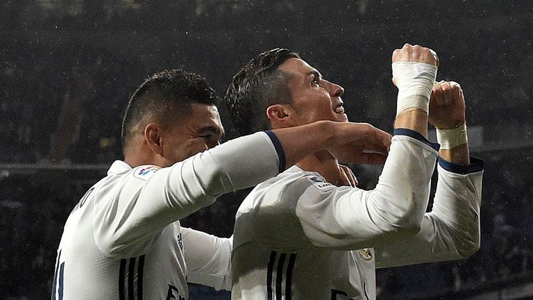 Real Madrid's Portuguese forward Cristiano Ronaldo (L) celebrates a goal with Real Madrid's Brazilian midfielder Casemiro 