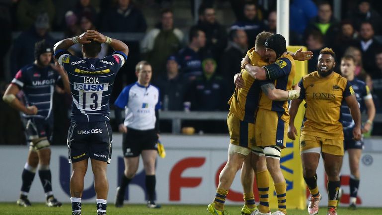 Johnny Leota stands dejected as Bristol's players celebrate their win over Sale Sharks
