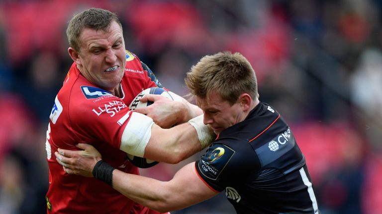 Hadleigh Parkes is tackled by Nick Tompkins of Saracens