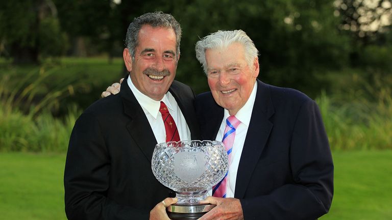 WOBURN, ENGLAND - SEPTEMBER 02:  Sam Torrance of Scotland receives the John Jacobs Trophy awarded to the Order of Merit winner from John Jacobs at the Annu