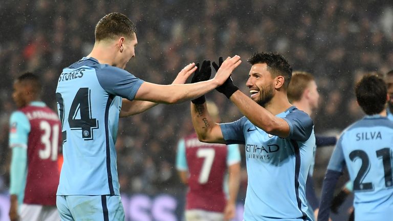 Manchester City's Argentinian striker Sergio Aguero (3rd R) celebrates with Manchester City's English defender John Stones after scoring their fourth goal 