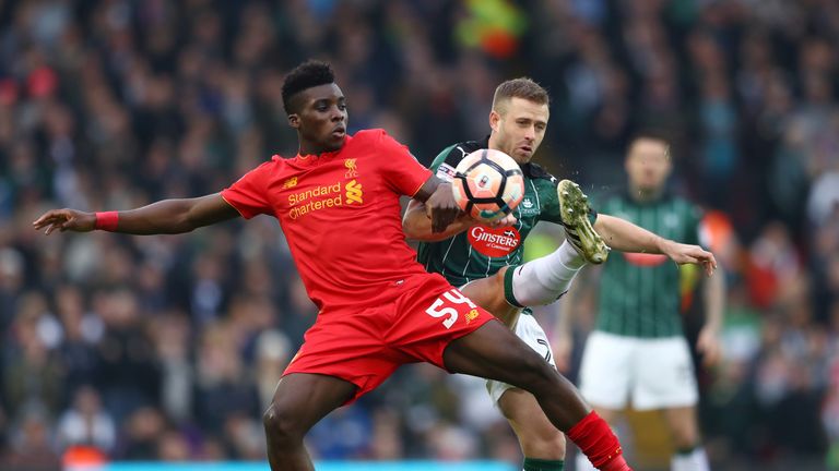 Sheyi Ojo of Liverpool (L) and David Fox of Plymouth Argyle (R) battle for possession