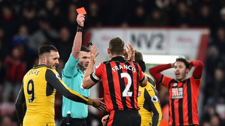 Referee Michael Oliver shows a red card to Bournemouth's English defender Simon Francis