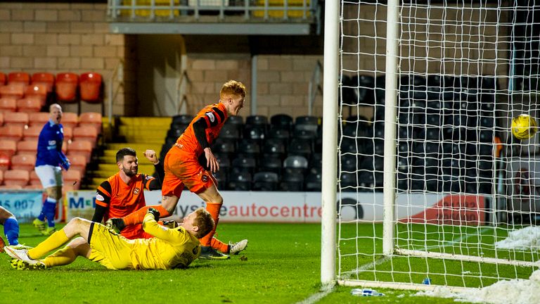 Simon Murray (centre) bundles home a late equaliser at Tannadice 