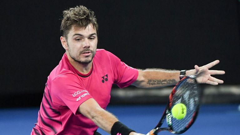 Switzerland's Stanislas Wawrinka hits a return against Switzerland's Roger Federer during their men's singles semi-final match on day 11 of the Australian 