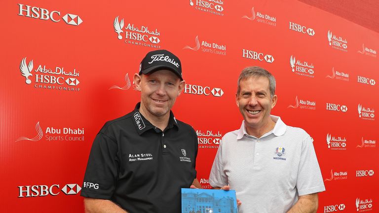 Stephen Gallacher is presented with a commemorative video book to recognise his 500th European Tour start
