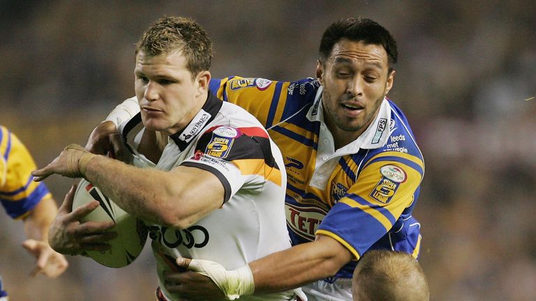 Stuart Fielden of Bradford is hauled down by Willie Poching and Andrew Dunemann of Leeds