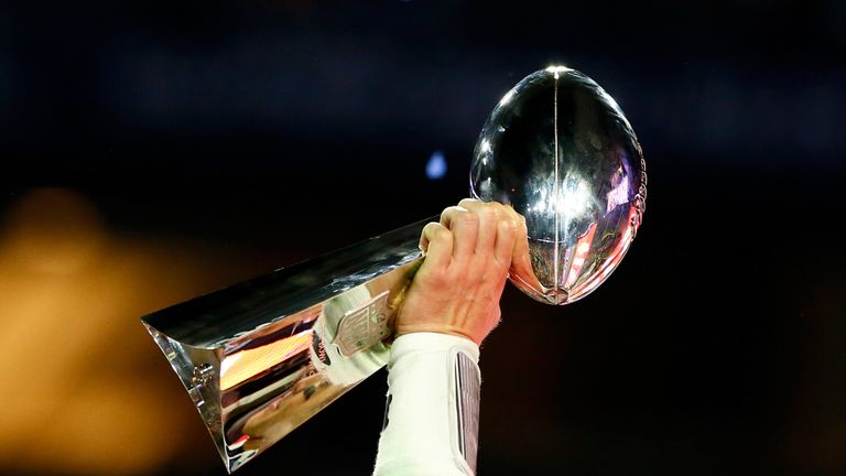 GLENDALE, AZ - FEBRUARY 01:  Tom Brady #12 of the New England Patriots celebrates holding the Vince Lombardi Trophy after defeating the Seattle Seahawks du