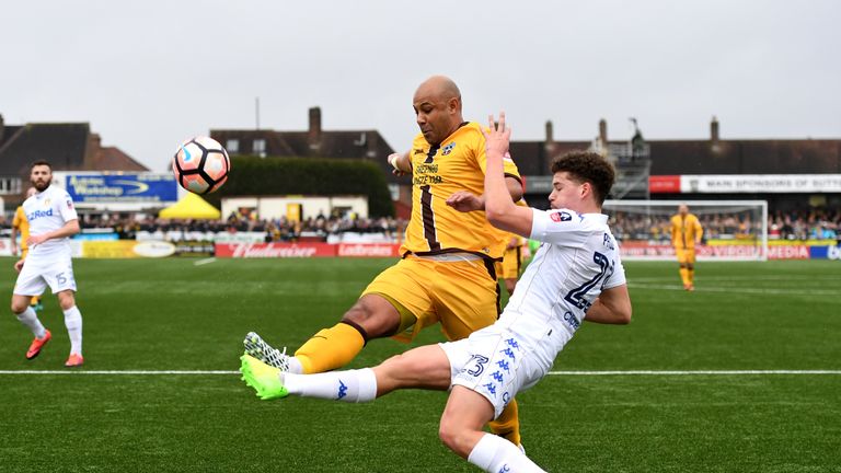 Simon Downer of Sutton United (L) and Kalvin Phillips of Leeds United (R) battle for possession 