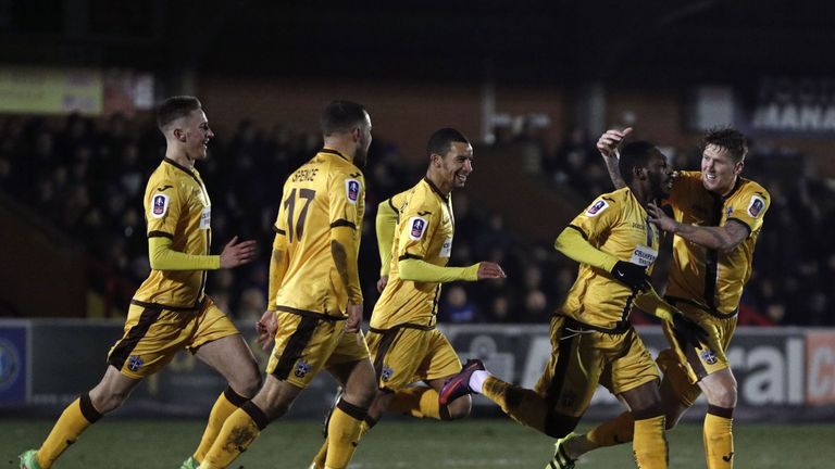 Sutton United's Roarie Deacon (2nd R) celebrates his equaliser with team-mates