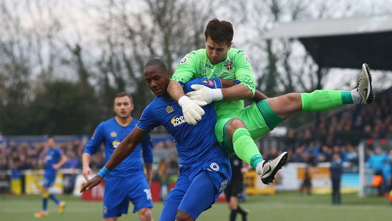 SUTTON, UNITED KINGDOM - JANUARY 07:  Tom Elliott of AFC Wimbledon and Ross Worner of Sutton United clash  during The Emirates FA Cup Third Round match bet