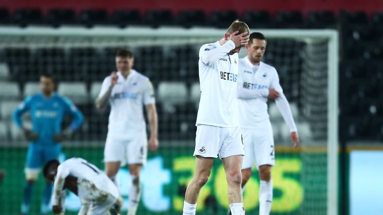 SWANSEA, WALES - DECEMBER 31: Swansea City players show their dejection after the Premier League match between Swansea City and AFC Bournemouth at Liberty 