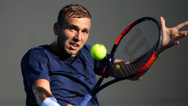 Dan Evans hits a return against Facundo Bagnis during their men's singles first round match on day one of the Australian Open