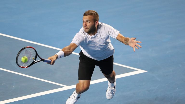 Dan Evans plays a backhand in his third round match against Bernard Tomic