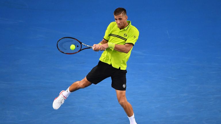 MELBOURNE, AUSTRALIA - JANUARY 16:  Martin Klizan of Slovakia plays a backhand in his first round match against Stan Wawrinka of Switzerland on day one of 
