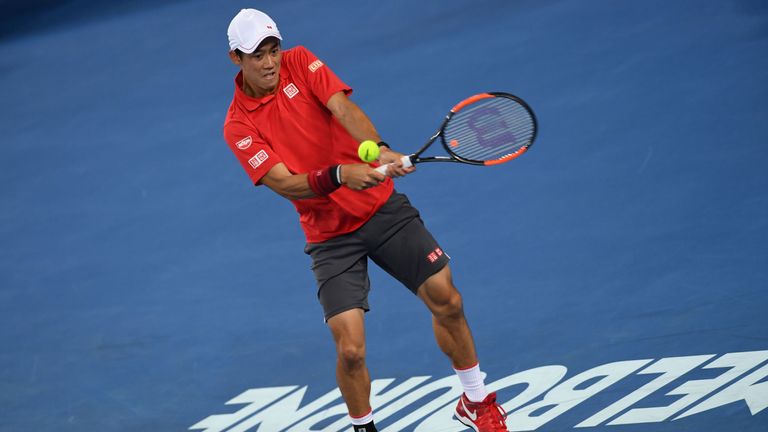 Japan's Kei Nishikori hits a return against Slovakia's Lukas Lacko during their men's singles third round match on day five of the Australian Open