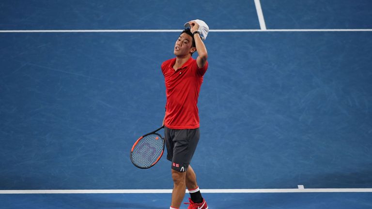 Kei Nishikori reacts while playing against Roger Federer during their men's singles fourth round match on day seven of the Australian Open