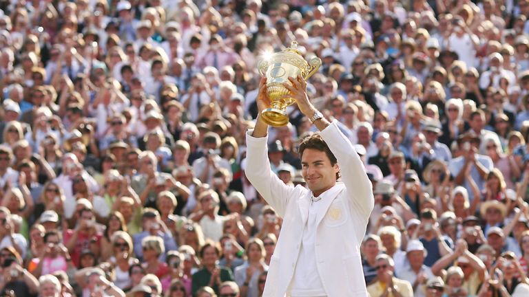 Roger Federer of Switzerland shows the trophy after defeating Rafael Nadal of Spain