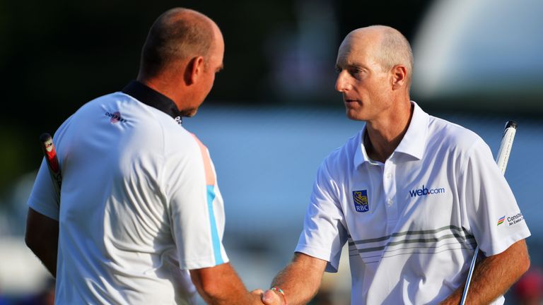 Jim Furyk shakes hands with Thomas Bjorn of Denmark on the 18th green at the 2013 PGA Championship