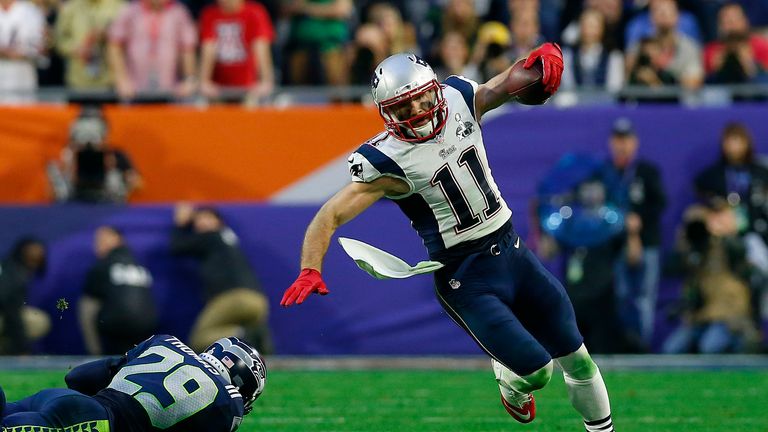 GLENDALE, AZ - FEBRUARY 01:  Julian Edelman #11 of the New England Patriots tries to avoid the tackle of  Earl Thomas #29 of the Seattle Seahawks during Su