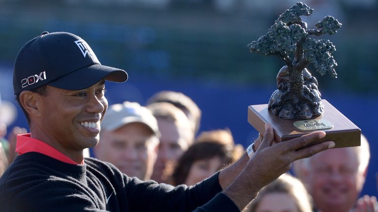 LA JOLLA, CA - JANUARY 28:  Tiger Woods holds the winner's trophy after his -14 under victory during the Final Round at the Farmers Insurance Open at Torre