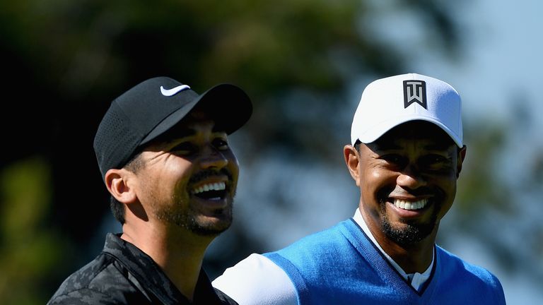 Jason Day and Tiger Woods share a laugh during the first round of the Farmers Insurance Open