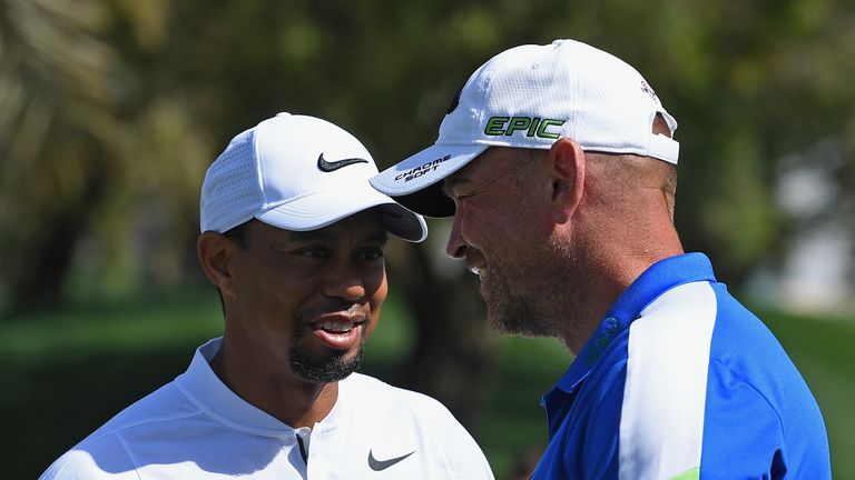 Woods is greeted by European Ryder Cup captain Thomas Bjorn on the range