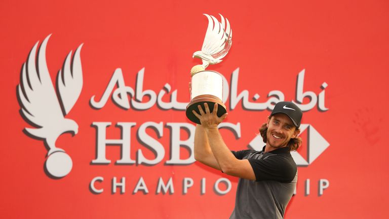 ABU DHABI, UNITED ARAB EMIRATES - JANUARY 22:  Tommy Fleetwood of England poses for photographs with the trophy after winning the tournament during the fin