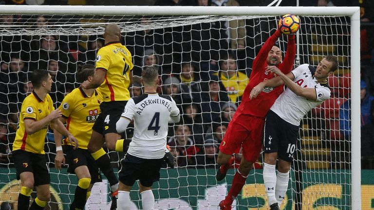 Watford's Brazilian goalkeeper Heurelho Gomes (2R) vies with Tottenham Hotspur's English striker Harry Kane during the English Premier League football matc