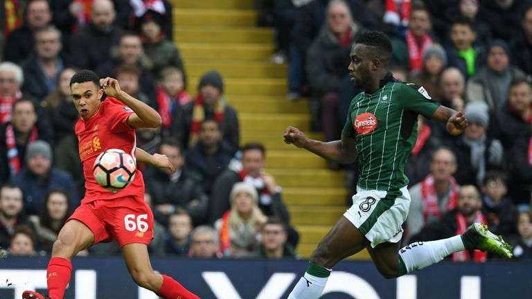 Liverpool's English midfielder Trent Alexander-Arnold (L) crosses the ball as Plymouth's English striker Jordan Slew closes in during the English FA Cup th