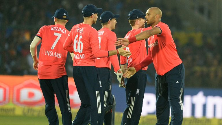 England bowler Tymal Mills (R) celebrates with his teammates after he dismissed India batsman Hardik Pandya during the first T20 match between India and En