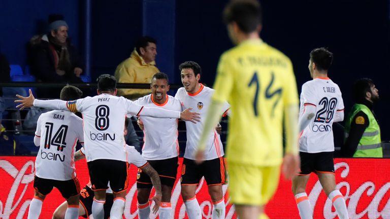 Valencia's players celebrate their second goal during the Spanish League football match Villarreal CF vs Valencia CF at El Madrigal stadium in Vila-real on