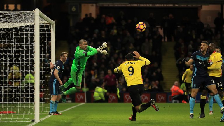 WATFORD, ENGLAND - JANUARY 14:  Vctor Valdes of Middlesbrough punches clear from Troy Deeney of Watford during the Premier League match between Watford and