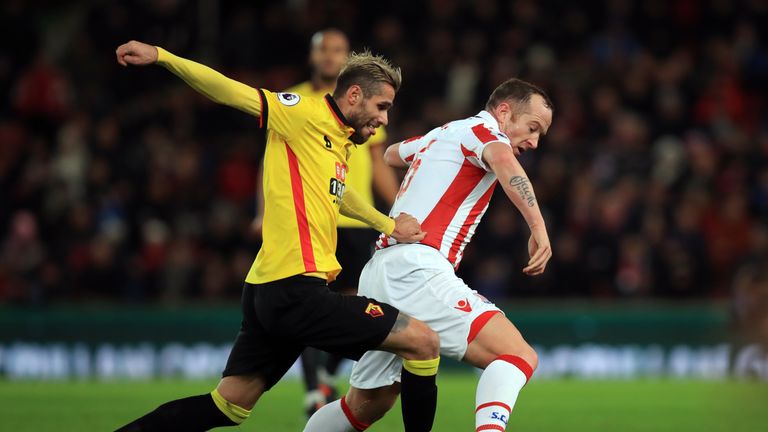 Watford's Valon Behrami and Stoke City's Charlie Adam (right) battle for the ball 