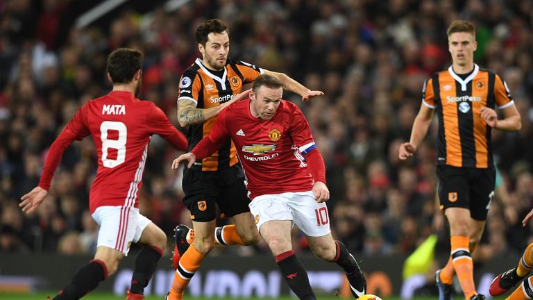 Wayne Rooney is closed down by Ryan Mason during the first half 