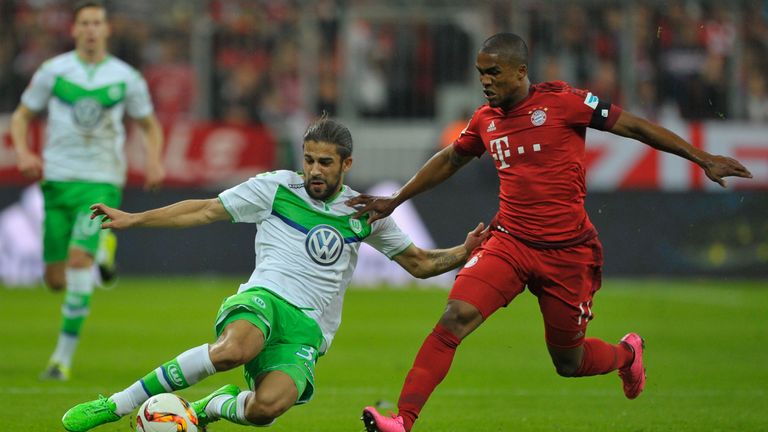 X of FC Bayern Muenchen challenges X of VfL Wolsburg during the Bundesliga match between FC Bayern Muenchen and VfL Wolfsburg at Allianz Arena on 