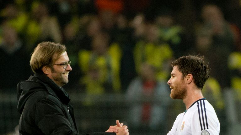 Real Madrid's midfielder Xabi Alonso (R) congratulates Dortmund's head coach Juergen Klopp (L) at the end of the UEFA Champions League Group D football mat